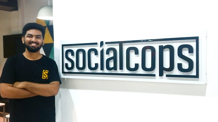 Siddharth in front of SocialCops sign
